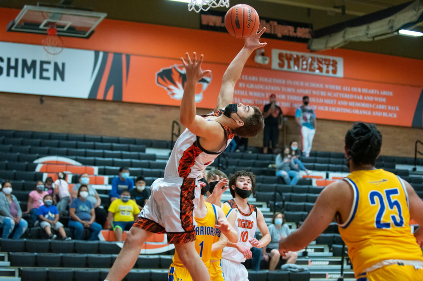 Centralia's Rex Akins leaps for an offensive rebound against Rochester on Wednesday.