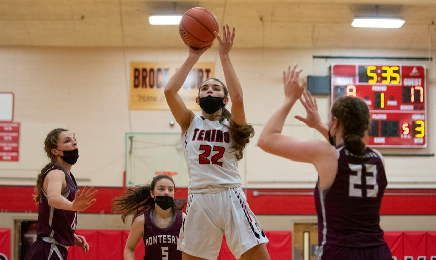 FILE PHOTO - Tenino junior Ashley Schow (22) splits two Montesano defenders then pulls up for a mid-range jumper against on Thursday.