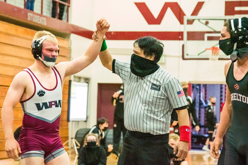 W.F. West&rsquo;s Evan Moon has his arm raised after winning a match during Sub-Districts Saturday morning in Chehalis.