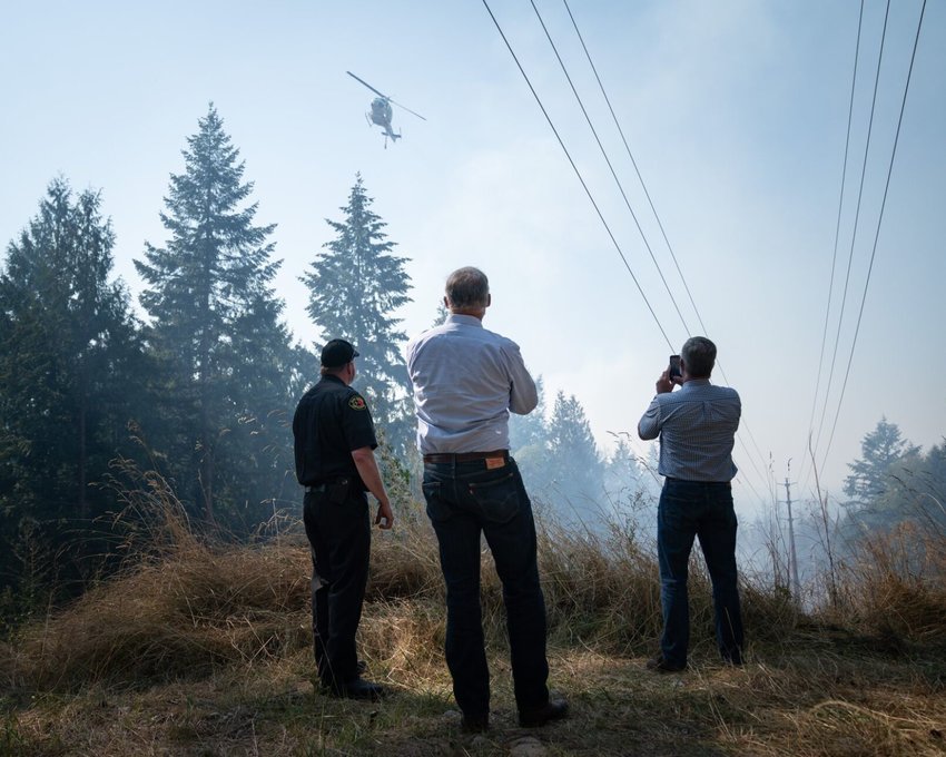 Gov. Jay Inslee tours fire damage in Pierce County last September.