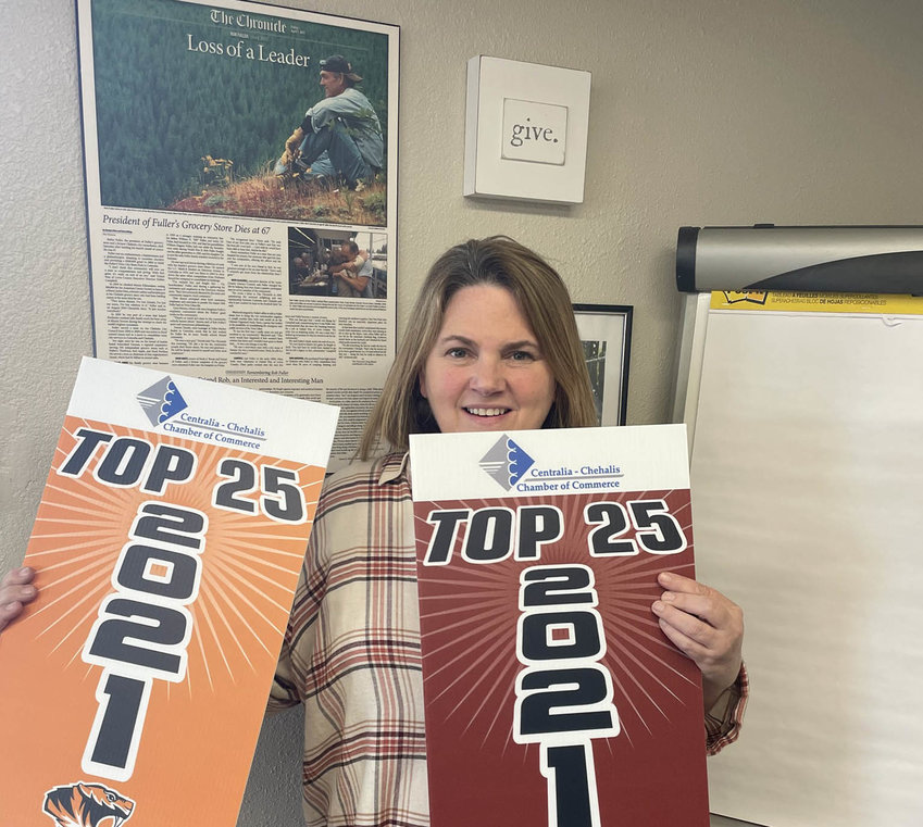 Chamber Executive Director Alicia Bull holds yard signs the chamber will be handing out to each of the top 25 students.