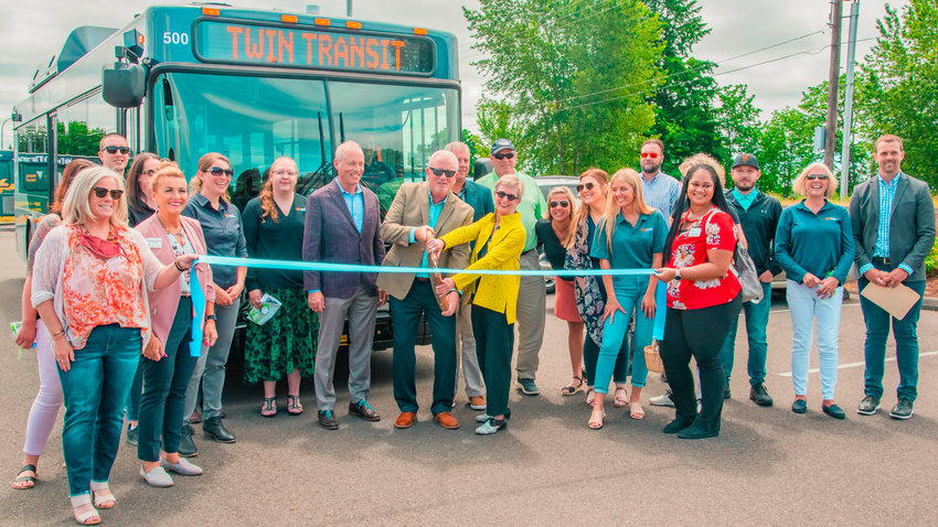 Community members pose for a photo during a ribbon cutting ceremony for the Mellen Street e-Transit Station in Centralia on Thursday.