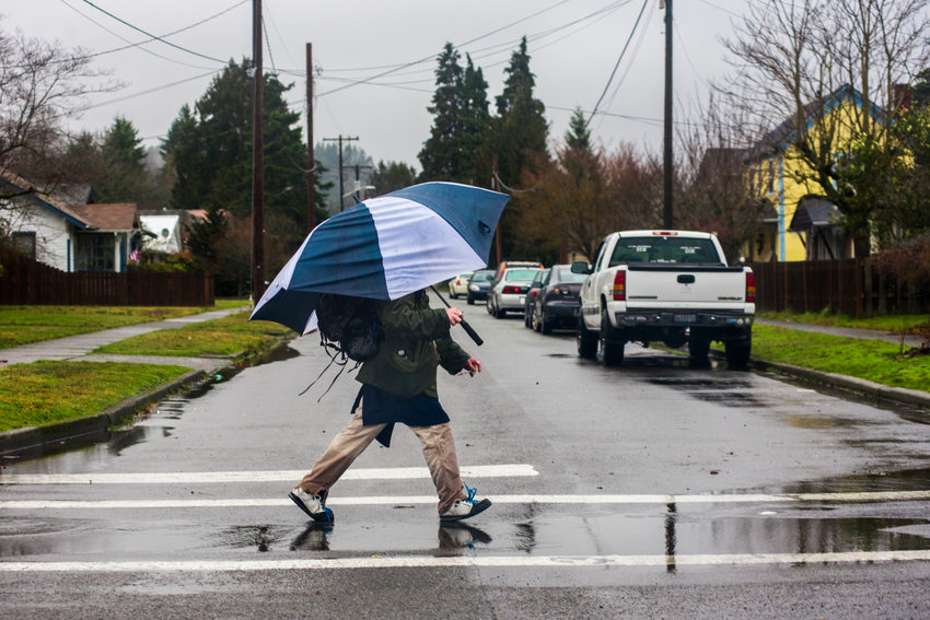 FILE PHOTO &mdash; A man walks through the rain while holding an umbrella in January 2020 in Centralia.