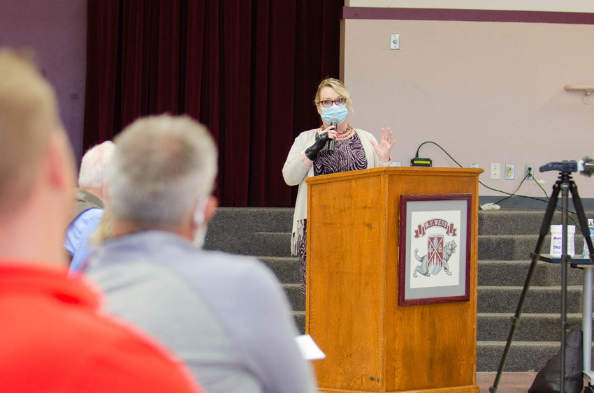 Superintendent Dr. Christine Moloney speaks to a packed house of attendees at a June 15 school board meeting. Many were in attendance to voice opposition to a state-mandated school policy about discrimination.