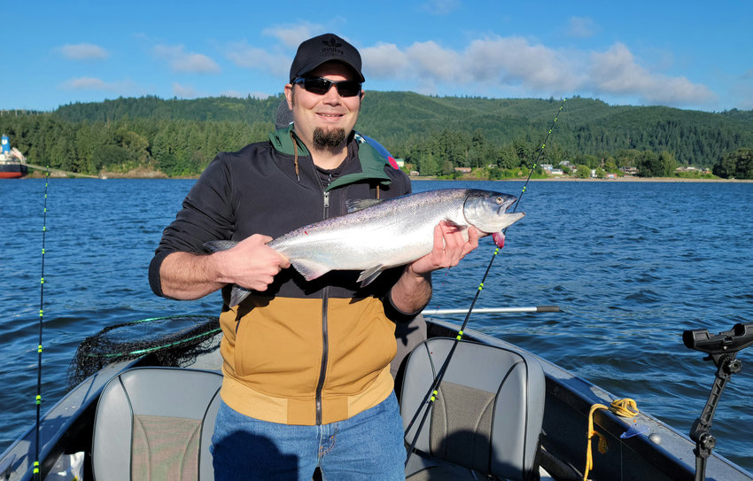 The Chronicle sports editor Eric Trent with a spring-run Chinook salmon he caught on the Columbia River on June 18, 2021.