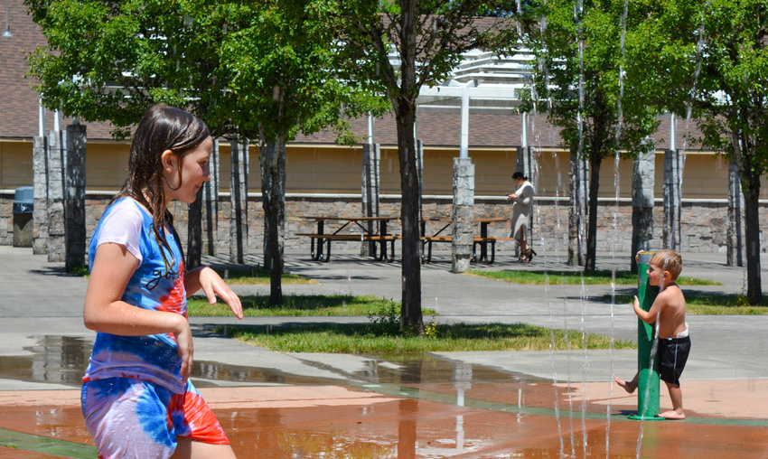 Children play at the splash pad at Kiwanis Park in Battle Ground.