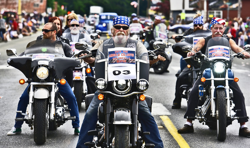 Oakville Mayor Angelo Cilluffo, leads a group of motorcycle riders as they participate in Oakville&rsquo;s Independence Day parade on Saturday, July 3. The club, called Real American Riding Enthusiasts (RARE), does a lot of charity work, Cilluffo said.