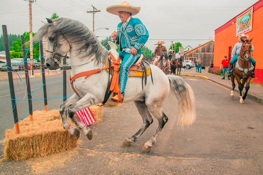 Horses dance to music outside Nachos Mexican Restaurant following the Freedom Festival parade on Saturday in downtown Mossyrock.