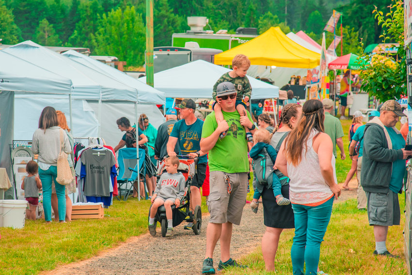 Visitors line up at vendors throughout Klickitat Prairie Park in Mossyrock during Freedom Festival celebrations last year.