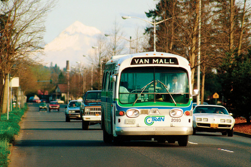 A C-TRAN bus makes its way down the road with Mt. Hood in the background during the system&rsquo;s first few years in the 1980s.