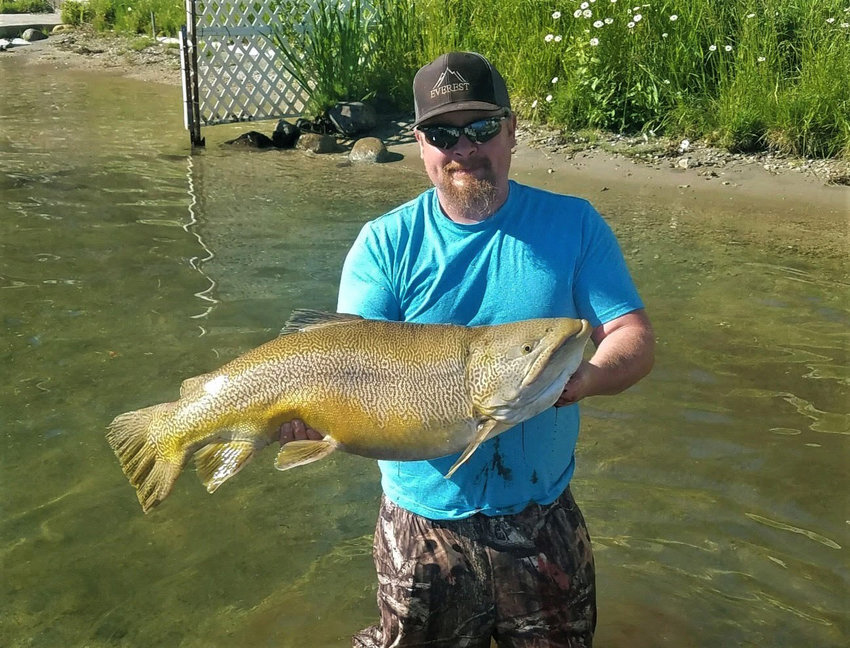Caylun Peterson with his state-record, 24.49-pound tiger trout in Loon Lake on June 26, 2021.