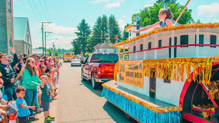 Candy is thrown to crowds from a Toledo Cheese Days float during a parade on Saturday.