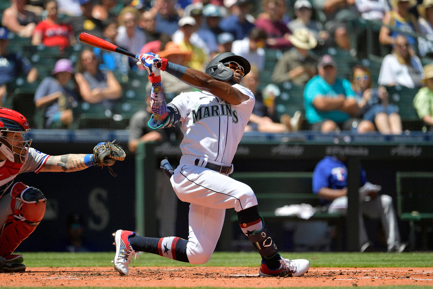 Shed Long Jr. (4) of the Seattle Mariners takes a big swing during the third inning against the Texas Rangers at T-Mobile Park on Sunday, July 4, 2021 in Seattle.