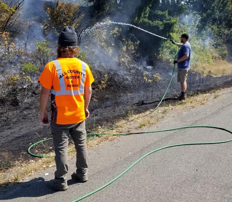 Trooper Robert Reyer posted this photo to Twitter along with this message: &quot;I just learned that these guys from All County Rooter &amp; Repair, who had been traveling south on I-5, turned to help avoid the fire from spreading into the fir trees on the northbound side before fire arrived! They had a 500 gallon water trailer.&quot;