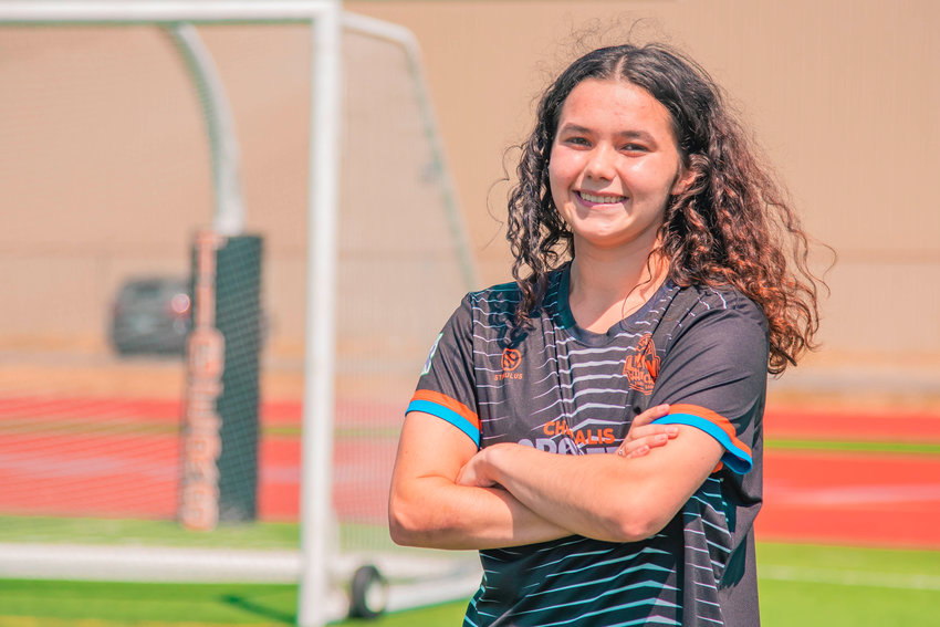 Ali Armstrong smiles and poses for a photo in front of soccer goals at Tiger Stadium in Centralia.