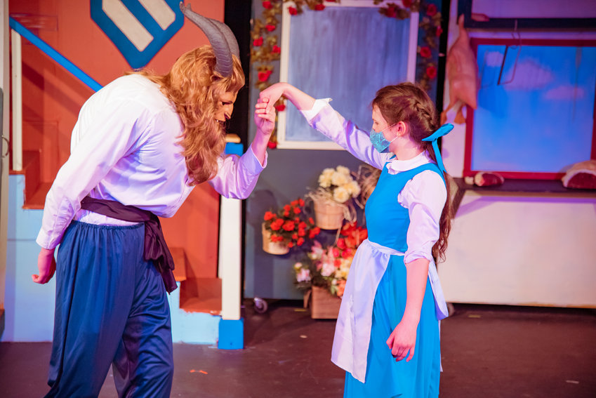 Nathan Crummett portraying the Beast and Lenora Page playing Belle sport masks during dress rehearsals for the Beauty and the Beast Musical Tuesday at the Evergreen Playhouse in Centralia.
