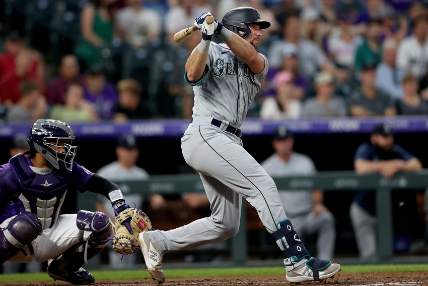 Cal Raleigh of the Seattle Mariners hits a two-run double against the Colorado Rockies in the sixth inning at Coors Field in Denver on July 20, 2021.