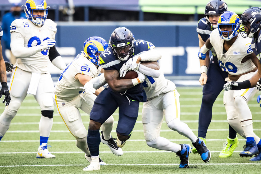 Seahawks running back Chris Carson rushes for a first down in the second quarter against the Los Angeles Rams on Dec. 27, 2020.