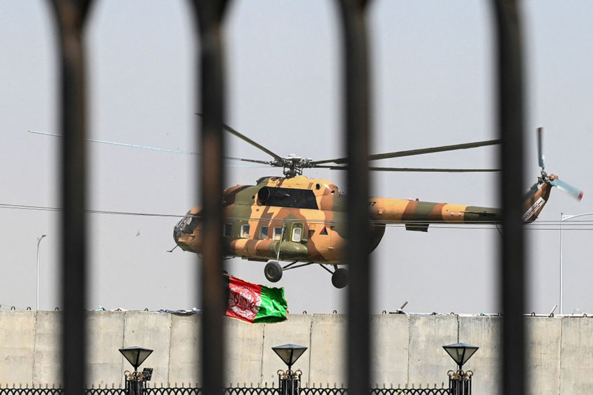 An Afghan Air Force's helicopter rovers near the Afghan Parliament house in Kabul on August 2, 2021. (Wakil Kohsar/AFP via Getty Images/TNS)
