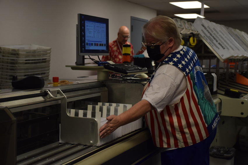Clark County elections worker Wendy Wimer processes ballots at the county elections office Aug. 3.