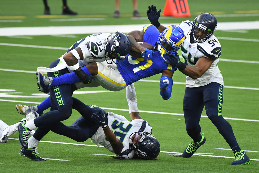 Los Angeles Rams tight end Gerald Everette is tackeled by Seattle Seahawks defenders, from left, Jamal Adams, Ryan Neal and Bobby Wagner after a catch in the second quarter on Sunday, Nov. 15, 2020 at SoFi Stadium in Inglewood, California.