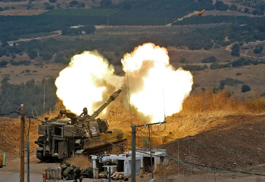 Israeli self-propelled howitzers fire towards Lebanon from a position near the northern Israeli town of Kiryat Shmona following rocket fire from the Lebanese side of the border, on August 6, 2021. (Jalaa Marey/AFP via Getty Images/TNS)