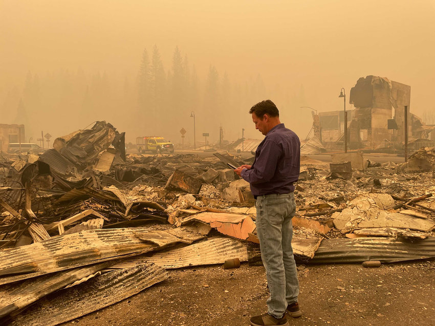 Plumas County Supervisor Kevin Goss surveys some of the destruction wrought by the Dixie fire in Greenville, California, on Friday. (Anita Chabria/Los Angeles Times/TNS)