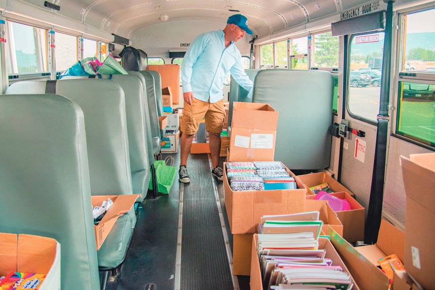 Peter Abbarno sorts through boxes of supplies in a school bus parked outside Walmart on Friday during the Centralia Back to School Supply Drive in 2021.