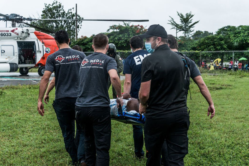 US Coast Guard transport an old man severely injured in the quake from the Ofatma hospital in Les Cayes to one of the hospitals in Port-au-Prince on August 17, 2021. (Reginald Louissaint Jr./AFP via Getty Images/TNS)