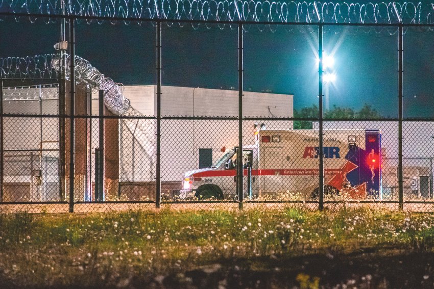 A paramedic unit is seen within the fences of the Green Hill School in Chehalis Sunday night.