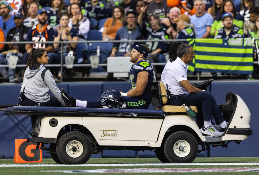 Seahawks linebacker Ben Burr-Kirven is taken off the field by cart after being injured on the opening kickoff against the Denver Broncos in a preseason game Aug. 21, 2021 in Seattle.