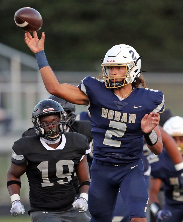 Hoban quarterback Jayvian Crable, right, throws a pass during the first half of a high school football game against Bishop Sycamore, Thursday, Aug. 19, 2021, in Akron, Ohio.
