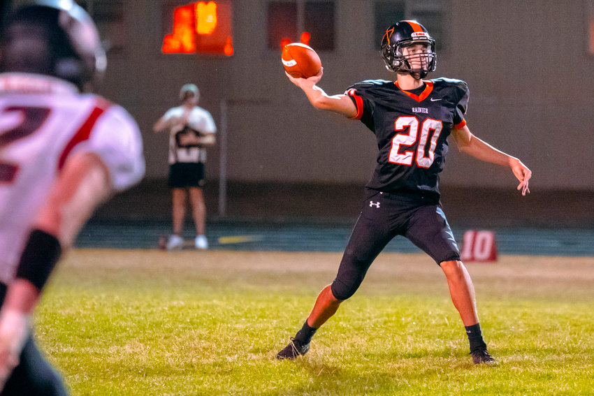Rainier&rsquo;s Ian Sprouffske (20) throws a pass during a Friday night game.