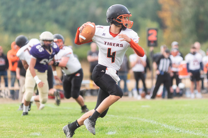 Sophomore Napavine quarterback Ashton Demarest rolls to his right to pass in the Tigers 34-20 win over Onalaska Friday night.