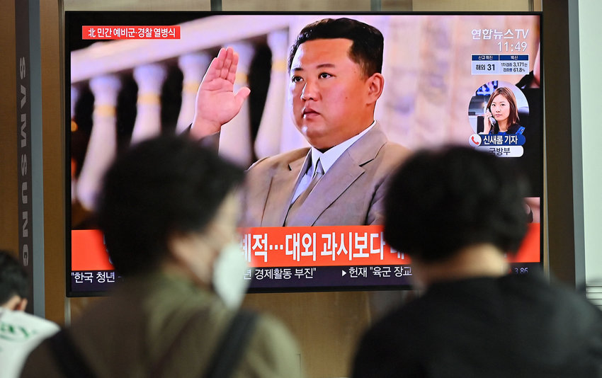 People watch a news program reporting on a parade marking the 73rd anniversary of the founding of North Korea held in Pyongyang, at a railway station in Seoul on Thursday, Sept. 9, 2021. (Jung Yeon-je/AFP/Getty Images/TNS)