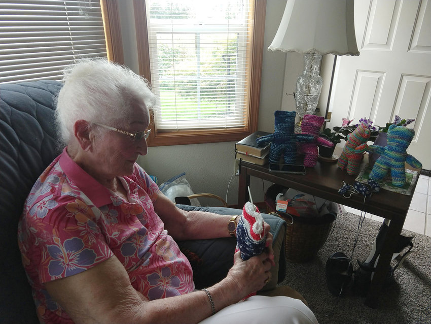 Shirley (French) Nelson, who turned 100 in July, holds a &ldquo;prayer bear&rdquo; that she knitted in this recent photo.