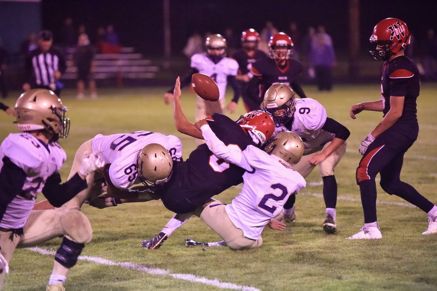 Multiple Onalaska defenders force a fumble from Wahkiakum&rsquo;s Dominic Curl on Sept. 17 in Cathlamet.