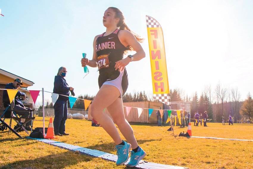 FILE PHOTO -- Rainier&rsquo;s Selena Niemi finishes first during a girls cross country meet during the 2020-21 season.