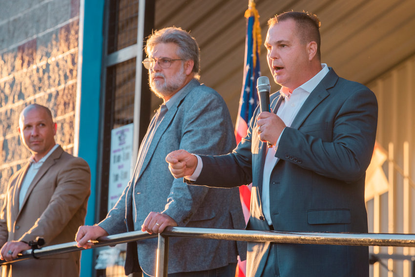Washington State Senator John Braun uses a microphone to speak to crowds during a town hall event at the Veterans Memorial Museum alongside state Reps. Peter Abbarno and Ed Orcutt Monday evening in Chehalis.