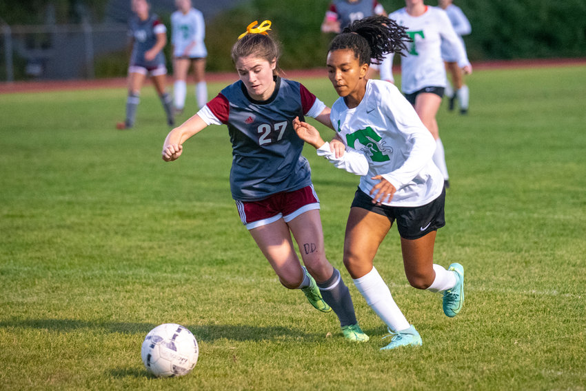 W.F. West senior Audrey Toynbee (27) and Tumwater junior Selly Beyene (11) battle for possession during a match in Chehalis on Tuesday.