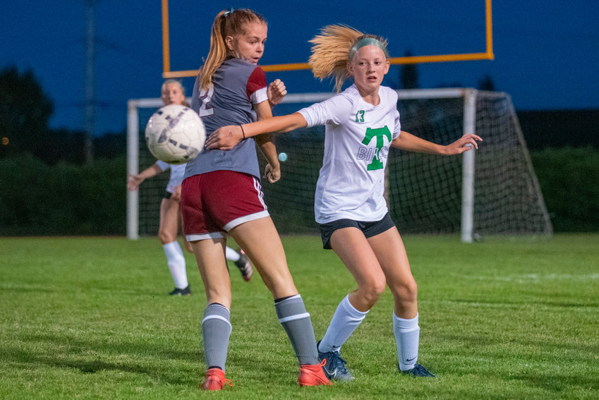FILE PHOTO-- Tumwater's Lucy Bergford (13) knocks the ball past W.F. West's Maddy Casper (2) earlier this season.