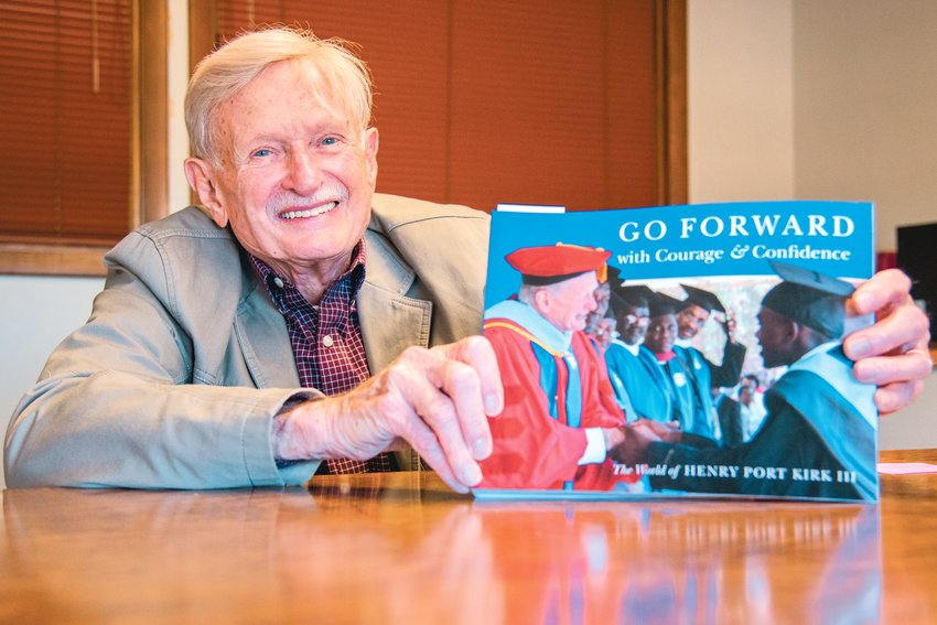 Henry Port Kirk III smiles and holds up his book &quot;Go Forward with Courage &amp; Confidence&quot; Tuesday in Centralia.