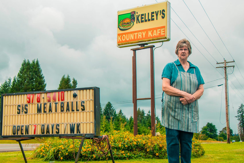 Reba Kelley poses for a photo in front of the Kelley&rsquo;s Kountry Kafe sign in 2020.