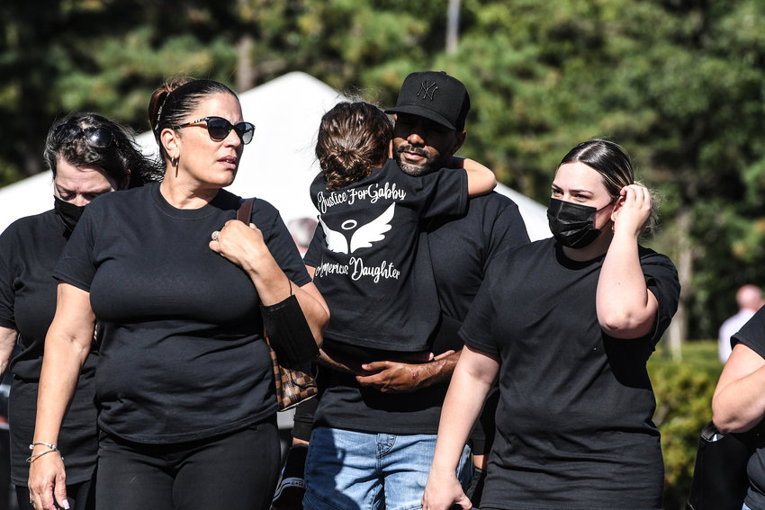 Mourners gather at a funeral home to pay respects to Gabby Petito on Sunday, September 26, 2021 in Holbrook, New York. As the search continues for a second week in Florida to find Brian Laundrie, who is a person of interest, the family of Gabby Petito is holding a public funeral in her hometown of Long Island. (Stephanie Keith/Getty Images/TNS)