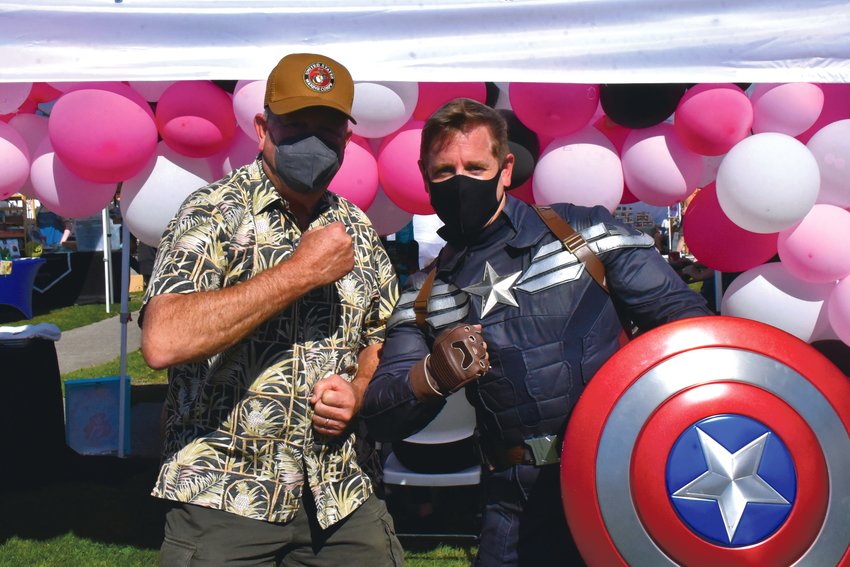 Mayor JW Foster tests his muscles with Captain America at the Yelm Fall Harvest Festival on Saturday, Sept. 25 at Yelm City Park.