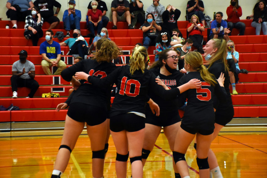 The Tornados celebrate during a set at a game against Peninsula High School on Thursday, Sept. 23 at Yelm High School.