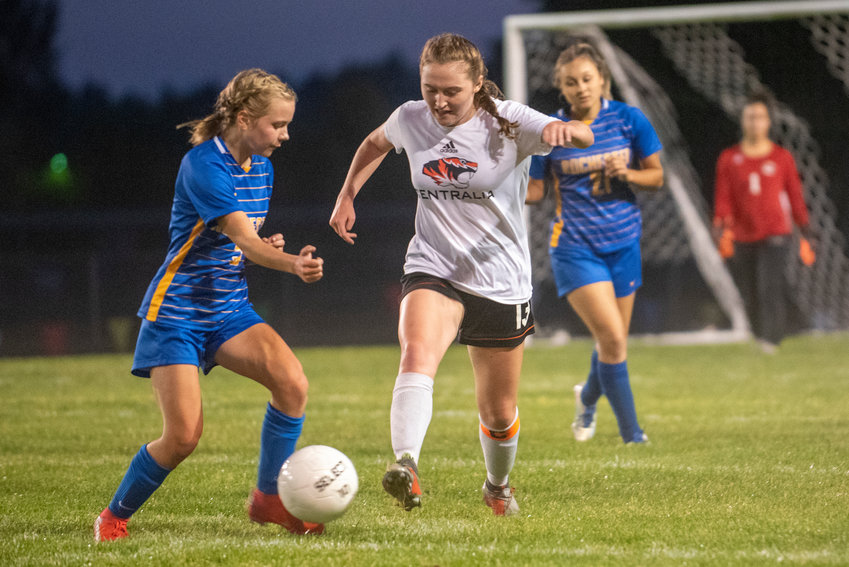 Centralia's Sarah Robbins (13) dribbles against Rochester's Piper Quarnstrom(5) in a match on Thursday in Rochester.