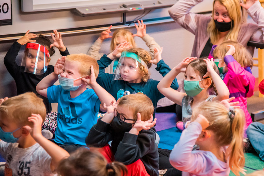 FILE PHOTO &mdash; Students enrolled in the Morton Elementary School Transitional Kindergarten program hold their hands on their head like antlers during a listening exercise last September.