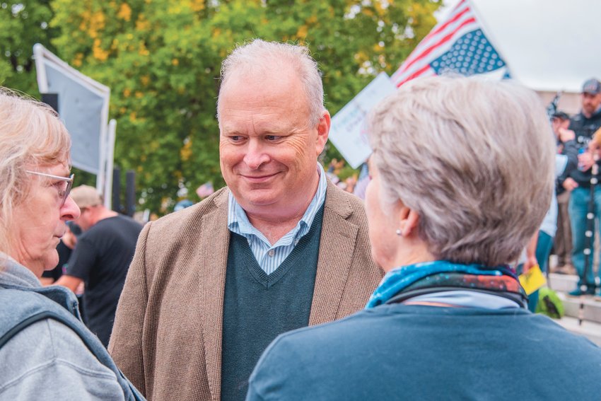 Representative Jim Walsh smiles while mingling with attendees of a &ldquo;Medical Freedom Rally&rdquo; outside the Washington State Capitol Building in October 2021.