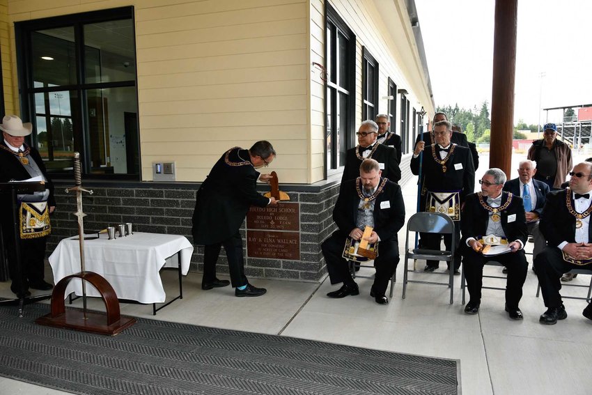Members of the Grand Lodge of Washington F&amp;AM rededicate the cornerstone of the high school during a ceremony on Sept. 21. Originally set by the Toledo Masonic Lodge in 1975, this stone signifies symbolically that the facility is level, plumb and square and that it will facilitate equality, right action and fairness, according to the Toledo School District.
